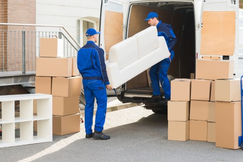 Packed moving boxes and furniture ready for transport