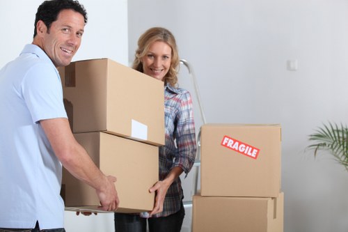 Movers handling items down stairs in a Harringay apartment block